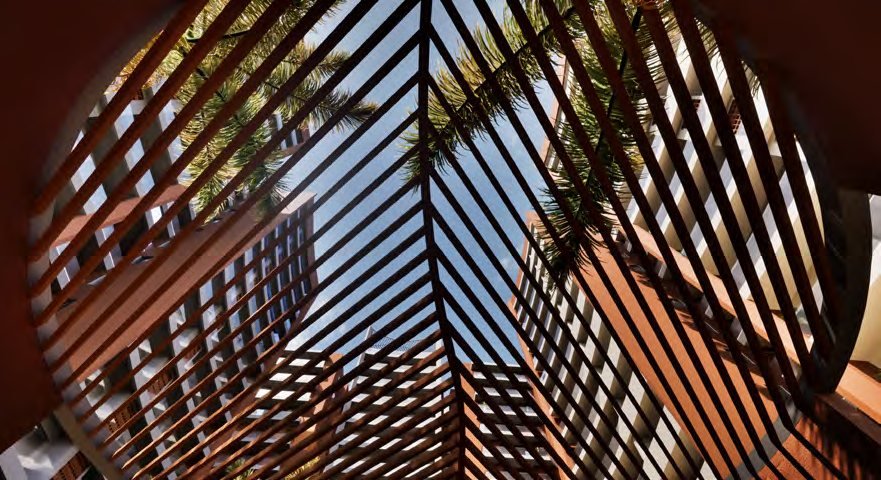 Fern Tellapur — curved fern-leaf façade screen detail seen from inside a balcony