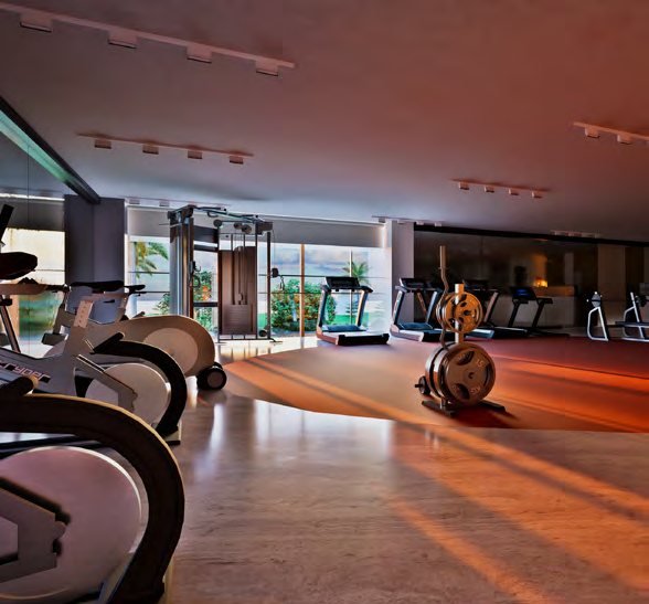 Fern Tellapur gymnasium with cardio equipment and full-height glazing